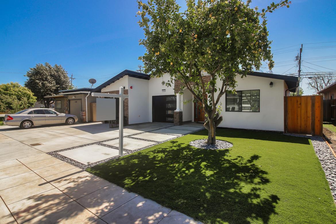 856 Howe Street San Mateo, CA 94401 - Photo 3 of 32 a front view of a house with a yard