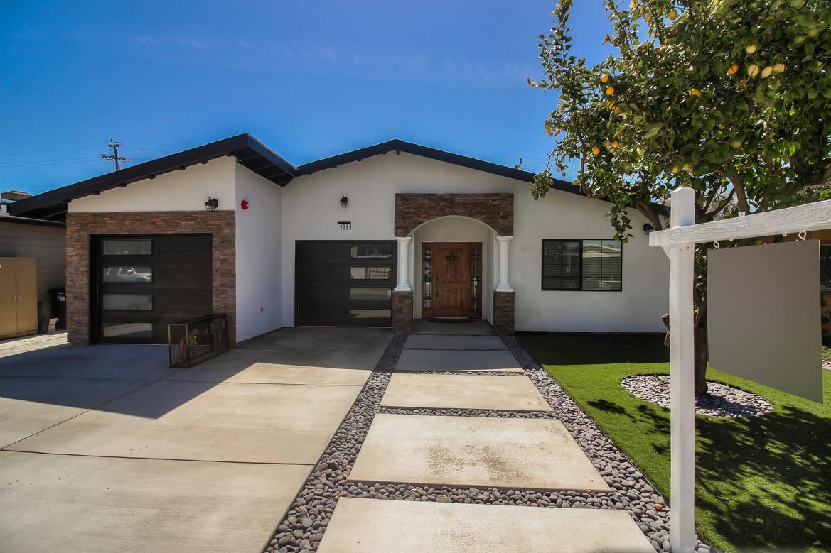 856 Howe Street San Mateo, CA 94401 - Photo 4 of 32 a front view of a house with a yard and garage