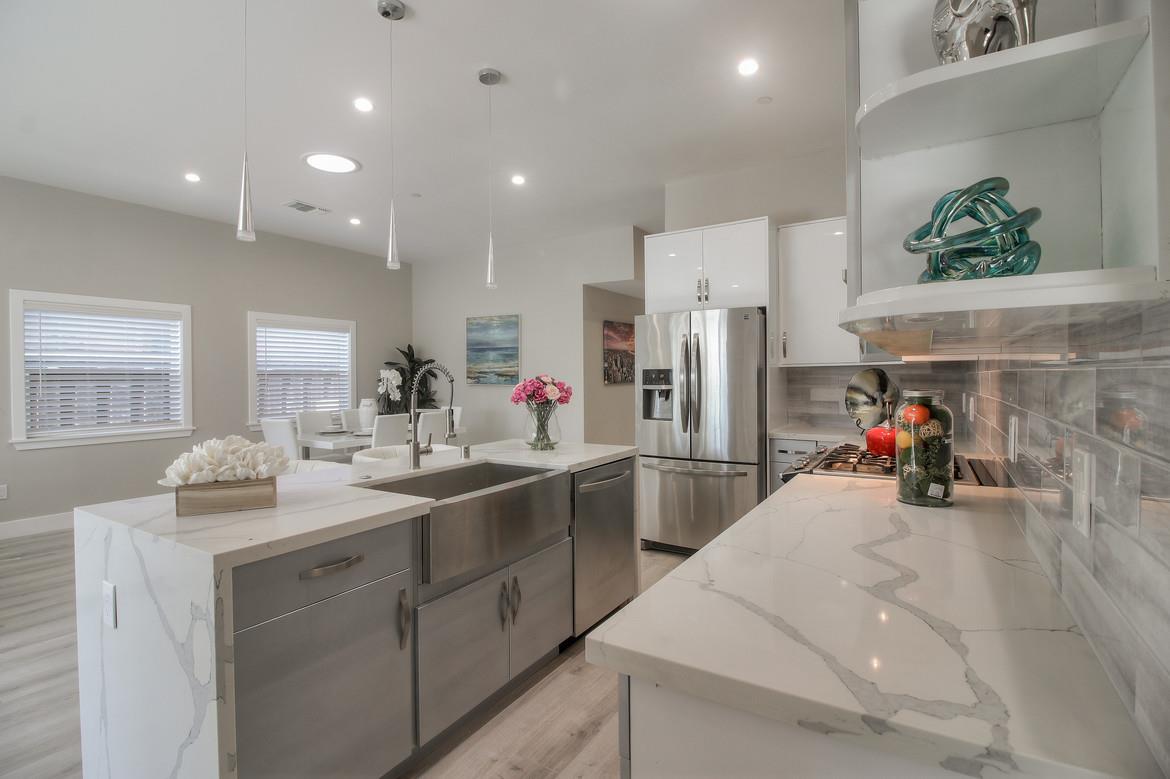 856 Howe Street San Mateo, CA 94401 - Photo 9 of 32 a kitchen with stainless steel appliances white cabinets and a sink