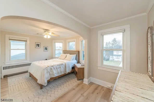 a bedroom with a large bed and a window