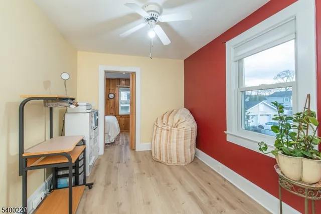 a view of a livingroom with furniture window wooden floor and a chandelier