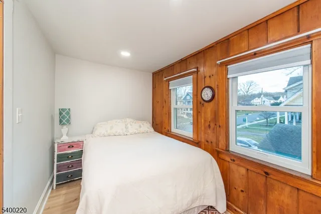a bedroom with a bed and a large window with outer view