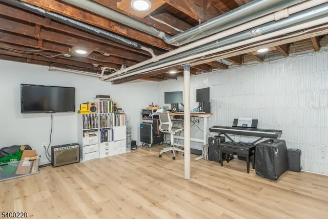 a view of a room with wooden floor and furniture
