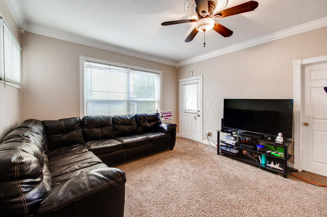 473 North Spring Street Elgin, IL 60120 - Photo 3 of 16 a living room with furniture and a flat screen tv