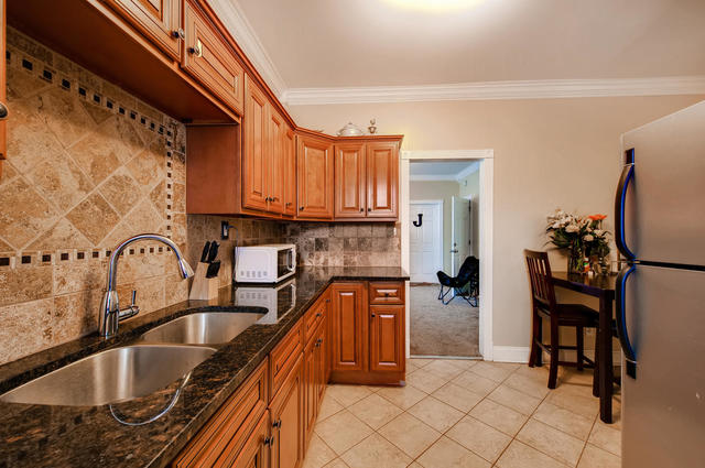 473 North Spring Street Elgin, IL 60120 - Photo 4 of 16 a kitchen with granite countertop a sink and cabinets