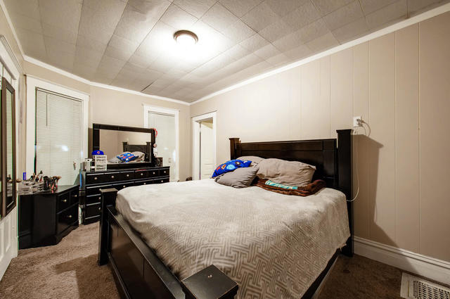 473 North Spring Street Elgin, IL 60120 - Photo 6 of 16 a bedroom with a bed and a flat screen tv