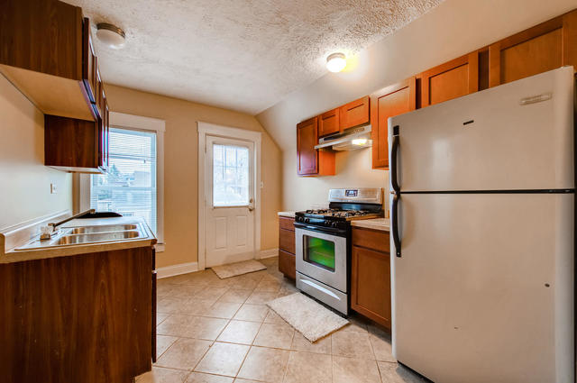 473 North Spring Street Elgin, IL 60120 - Photo 10 of 16 a kitchen with stainless steel appliances granite countertop a refrigerator a stove a sink and a microwave