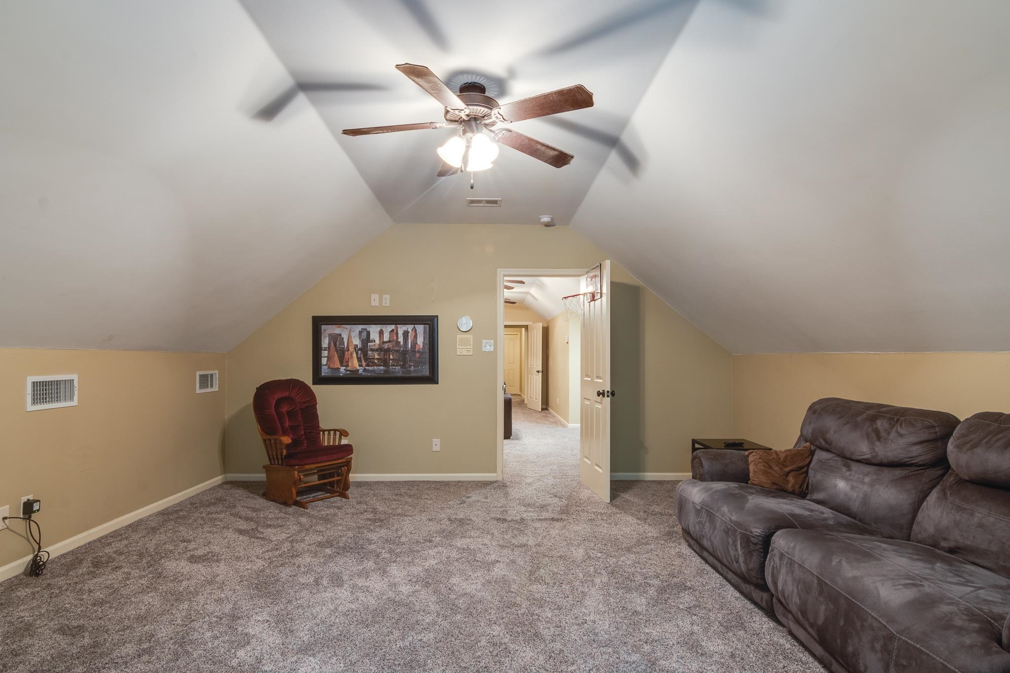 791 North Tree Drive Collierville, TN 38017 - Photo 22 of 27 Carpeted bonus room featuring a ceiling fan with integrated lighting, sloped ceilings, and neutral wall tones