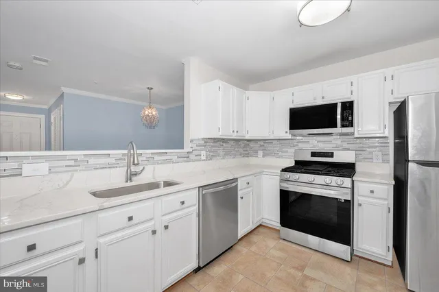a kitchen with a sink stove and microwave