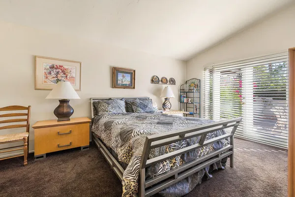 a bedroom with a bed and a dresser
