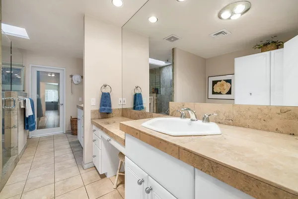 a large bathroom with a tub shower and sink