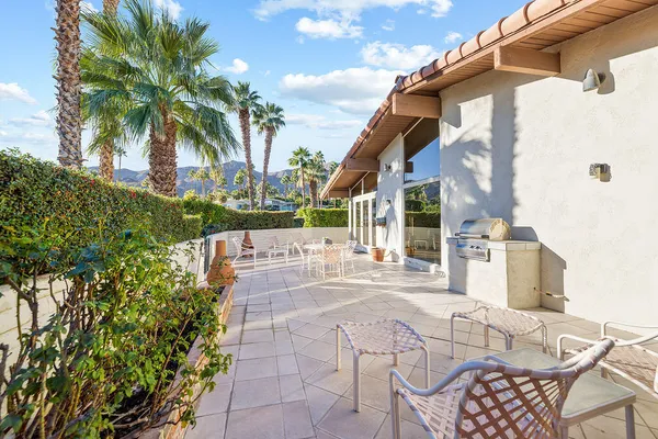 a view of yard from deck with patio