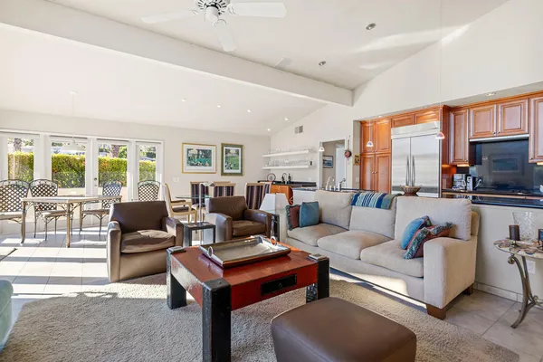 a kitchen with stainless steel appliances granite countertop a sink and a refrigerator
