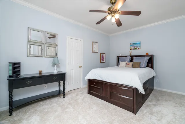 a spacious bedroom with a bed and a chandelier