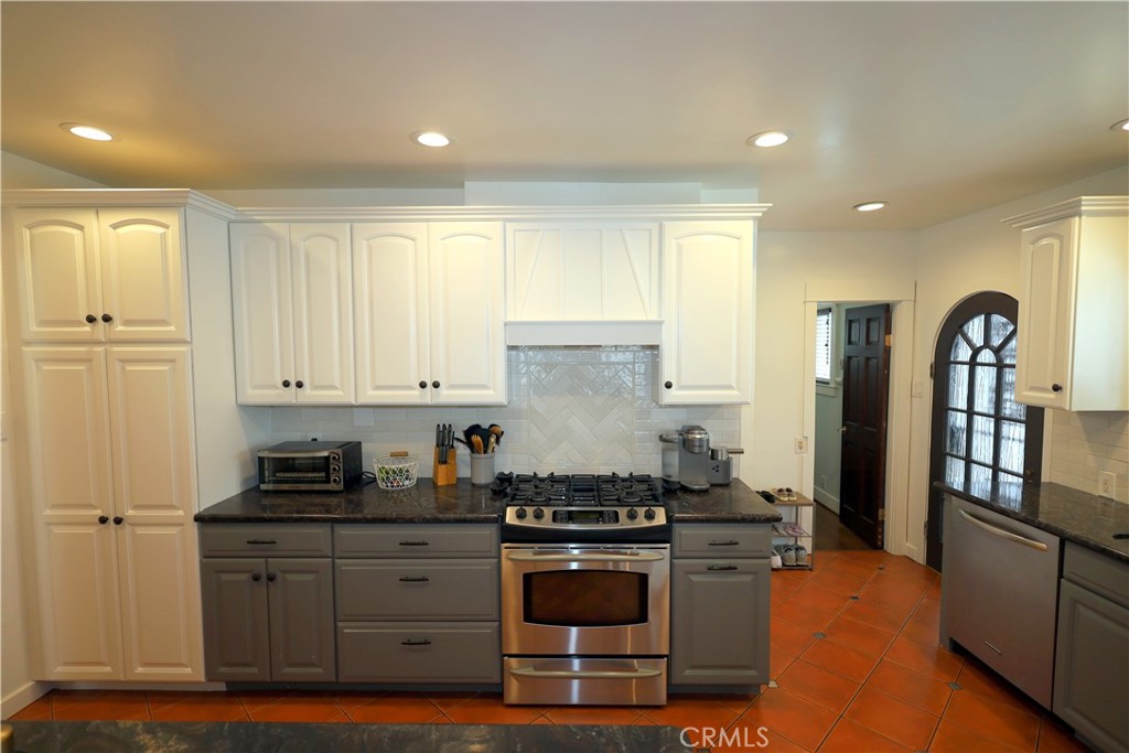 226 Orizaba Avenue Long Beach, CA 90803 - Photo 13 of 39 a kitchen with stainless steel appliances granite countertop a stove a sink and a refrigerator