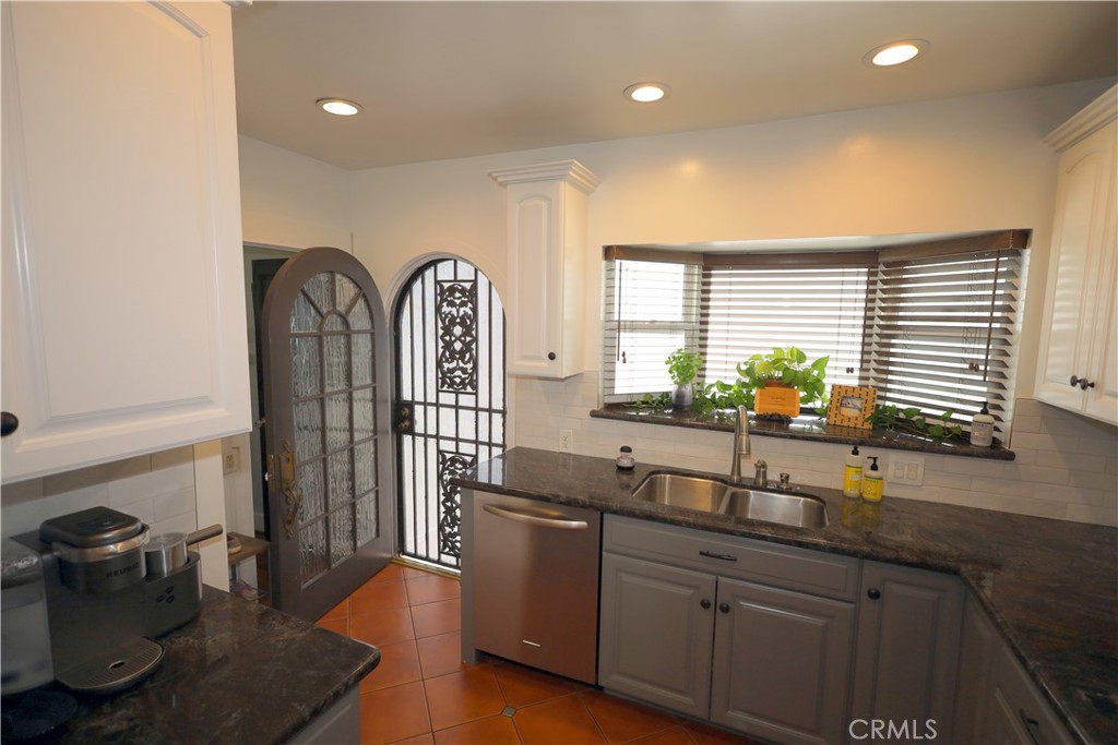 226 Orizaba Avenue Long Beach, CA 90803 - Photo 14 of 39 a kitchen with stainless steel appliances granite countertop a sink a stove and wooden floors
