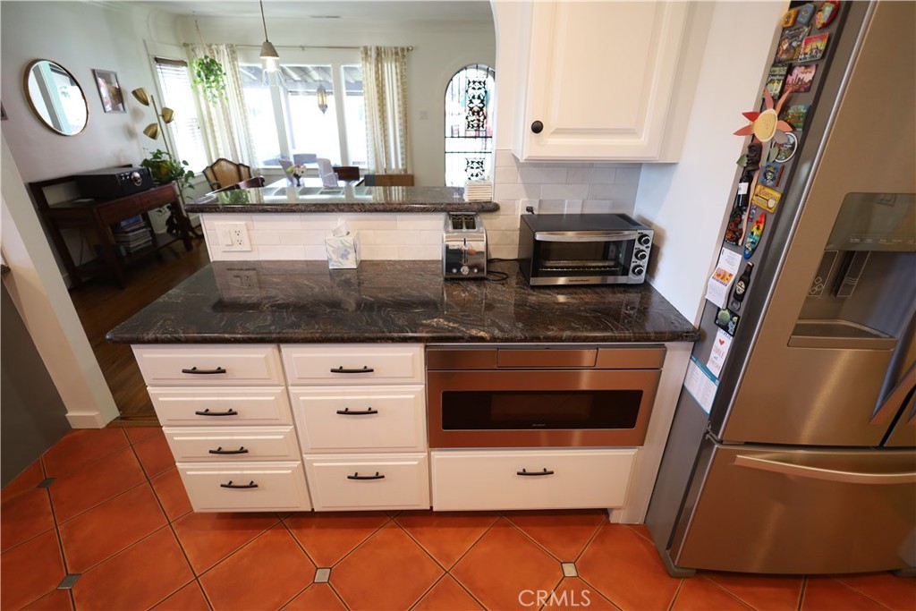 226 Orizaba Avenue Long Beach, CA 90803 - Photo 16 of 39 a kitchen with stainless steel appliances granite countertop a stove a sink and a refrigerator