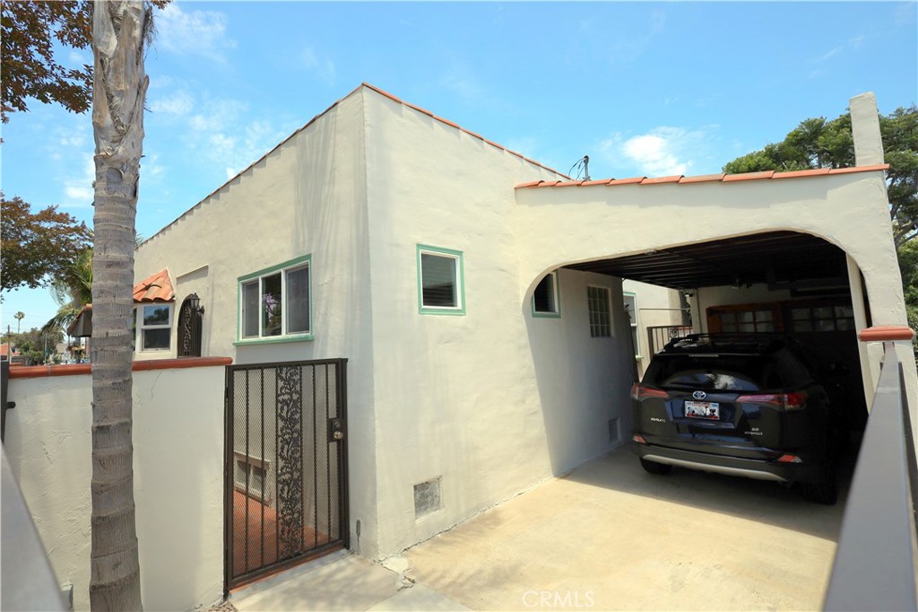 226 Orizaba Avenue Long Beach, CA 90803 - Photo 35 of 39 a car parked in front of a house with wooden fence