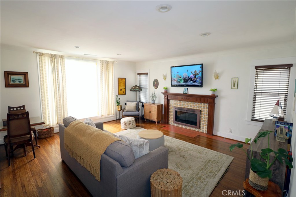 226 Orizaba Avenue Long Beach, CA 90803 - Photo 5 of 39 a living room with furniture a fireplace and a flat screen tv