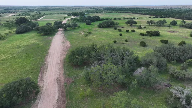 an aerial view of huge green field with lots of green space in it