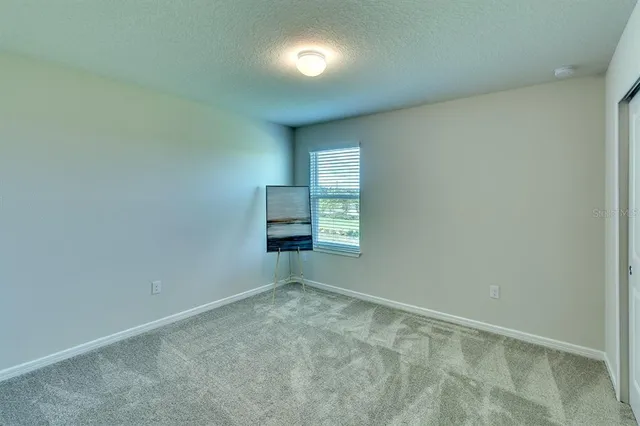 an empty room with a empty space and windows