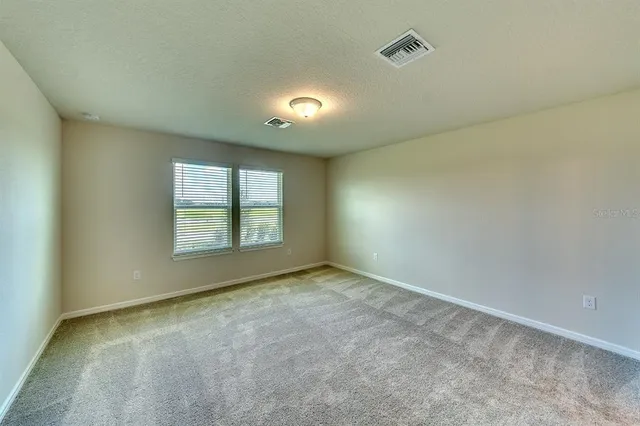 a bathroom with double vanity and a mirror