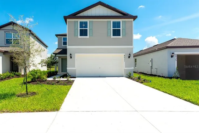 a view of a big yard with swimming pool table and chairs