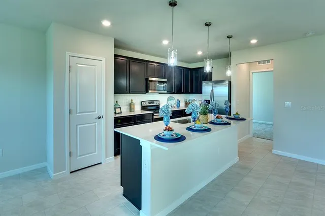 a kitchen with refrigerator and cabinets