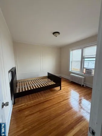 a view of a room with wooden floor and windows