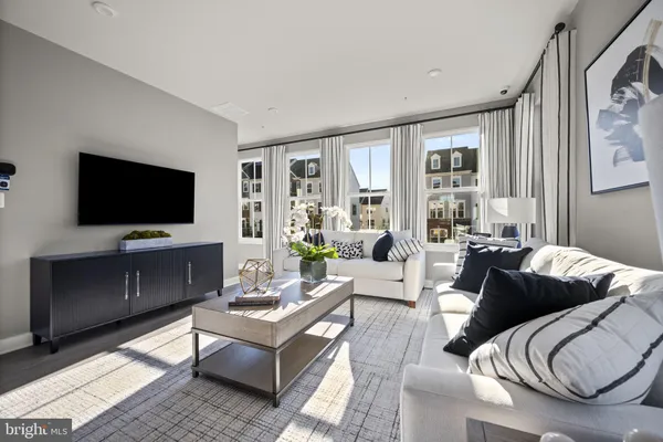 a living room with furniture a flat screen tv and a fireplace