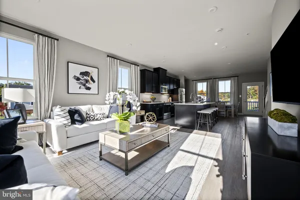 a living room with furniture and large window