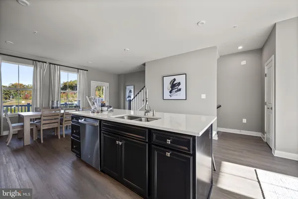 a kitchen with granite countertop a dining table and chairs