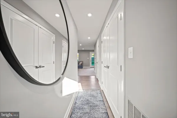 a view of a hallway with wooden floor and staircase