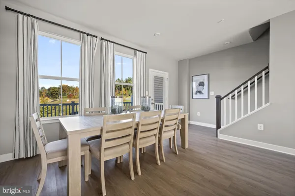 a kitchen with granite countertop a dining table and chairs