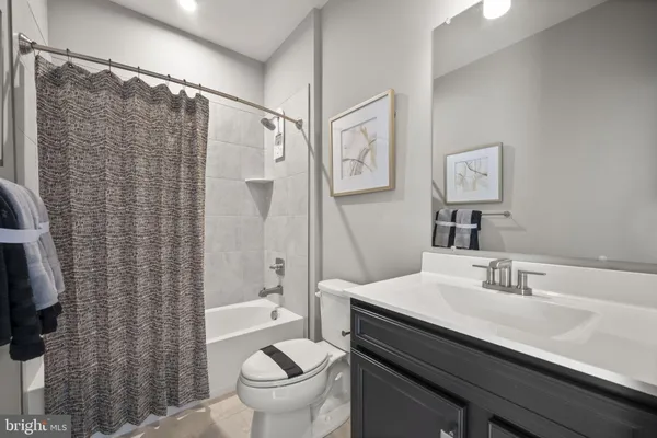 a bathroom with a double vanity sink toilet and shower