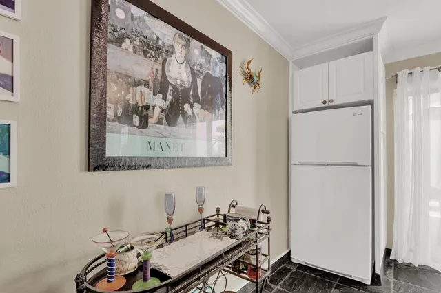a bathroom with a sink and a refrigerator