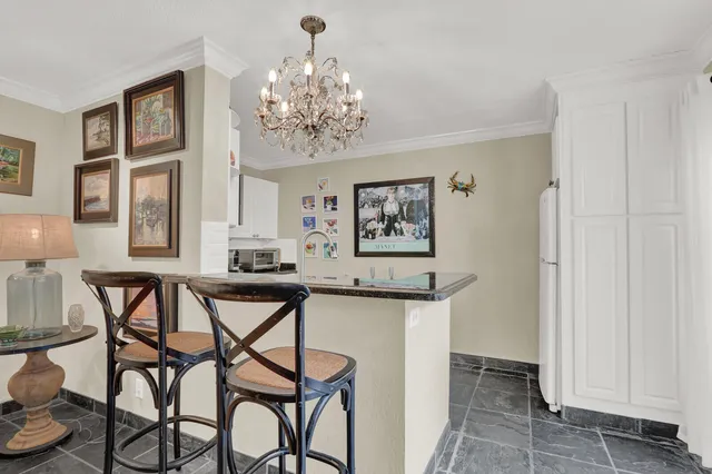 a view of a dining room with furniture and chandelier