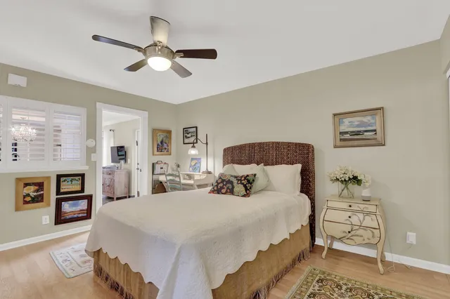 a bedroom with a large bed and a chandelier