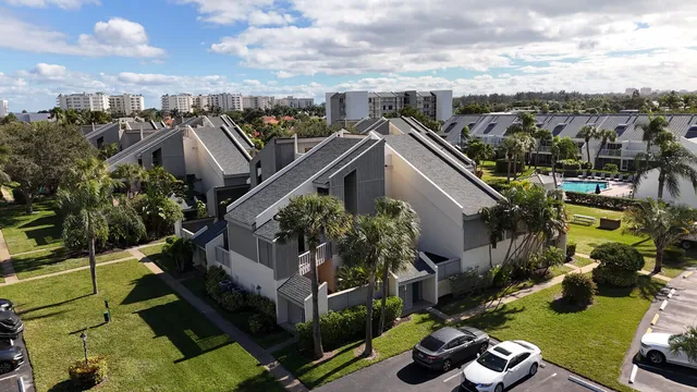 a front view of house with yard and lake view