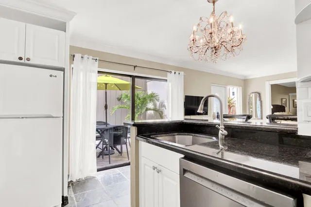 a view of a kitchen area with furniture and chandelier