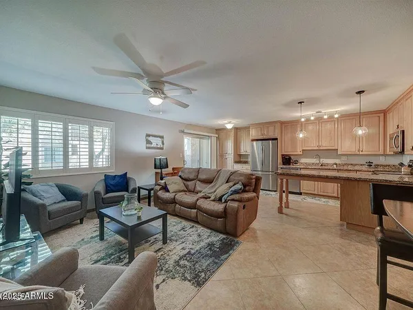 a living room with furniture and kitchen view