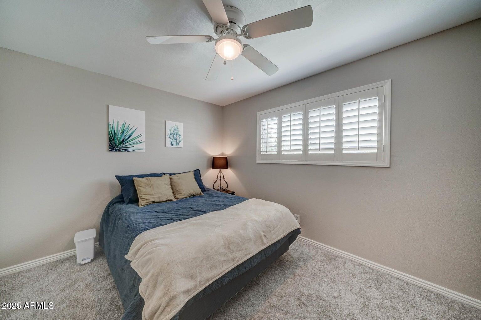 5525 East Thomas Road, Unit H3 Phoenix, AZ 85018 - Photo 6 of 7 a bedroom with a bed and a chandelier