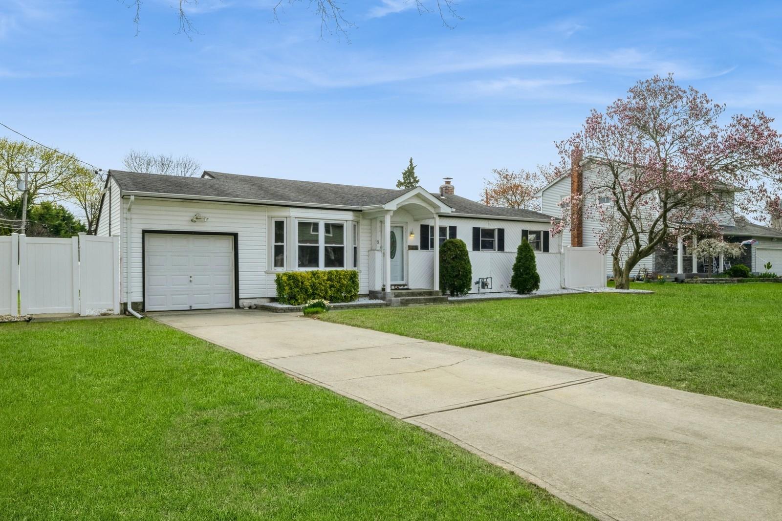 5 Crest Lane Commack, NY 11725 - Photo 1 of 1 Single story home with fence, a front lawn, a gate, an attached garage, and driveway