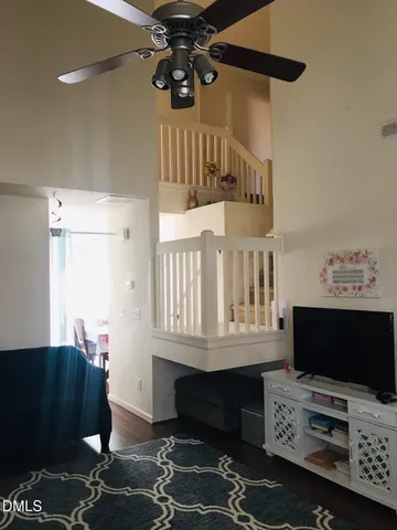 a bedroom with furniture a flat screen tv and a window