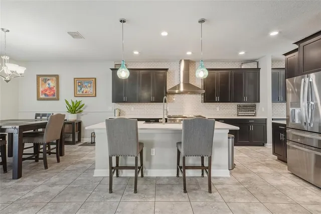 a kitchen with stainless steel appliances granite countertop a sink a stove and a refrigerator