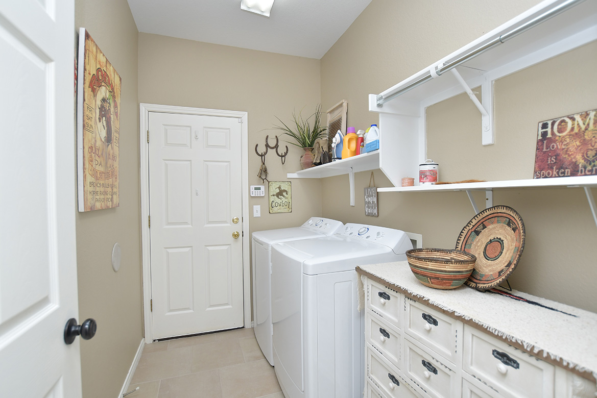 212 Bonham Loop Georgetown, TX 78633 - Photo 12 of 21 The laundry room is located between kitchen and garage, so carrying in groceries is effortless.