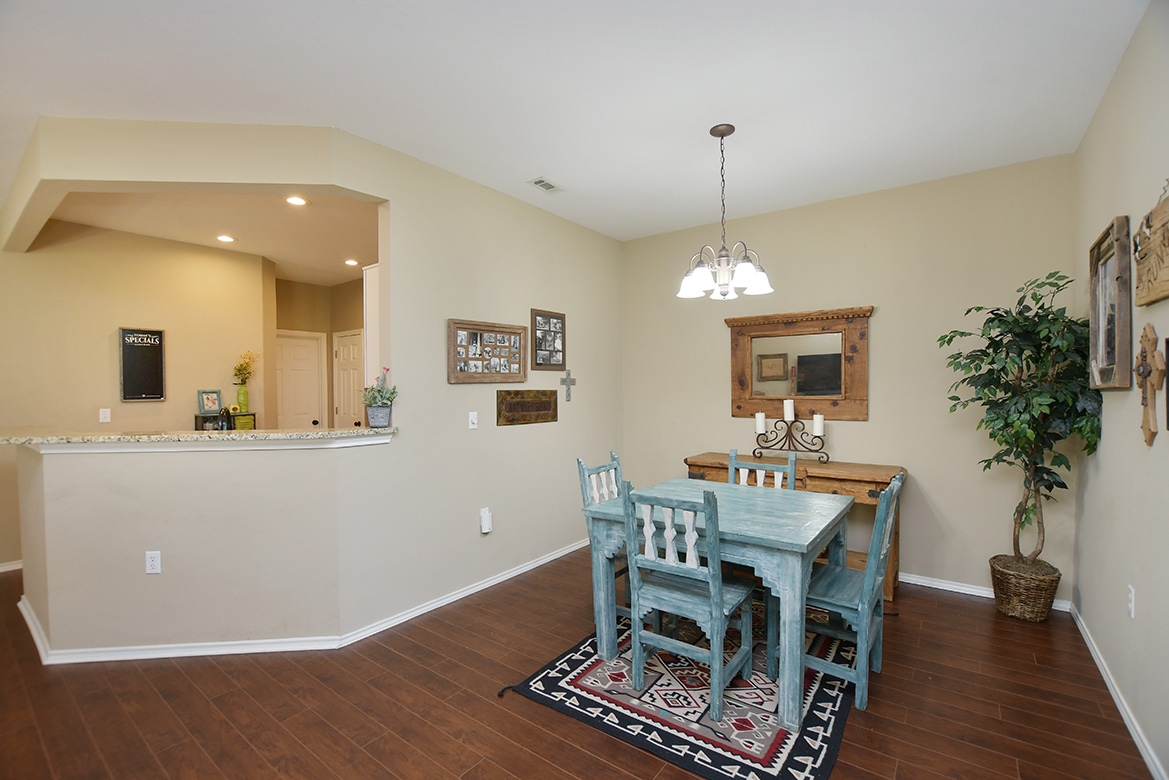 212 Bonham Loop Georgetown, TX 78633 - Photo 14 of 21 Rich 'wood-look' laminate flooring marries the open living/dining areas together.