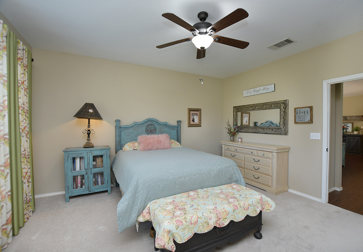 212 Bonham Loop Georgetown, TX 78633 - Photo 16 of 21 Newly installed carpet is found in the primary bedroom with its en-suite bathroom nearby.