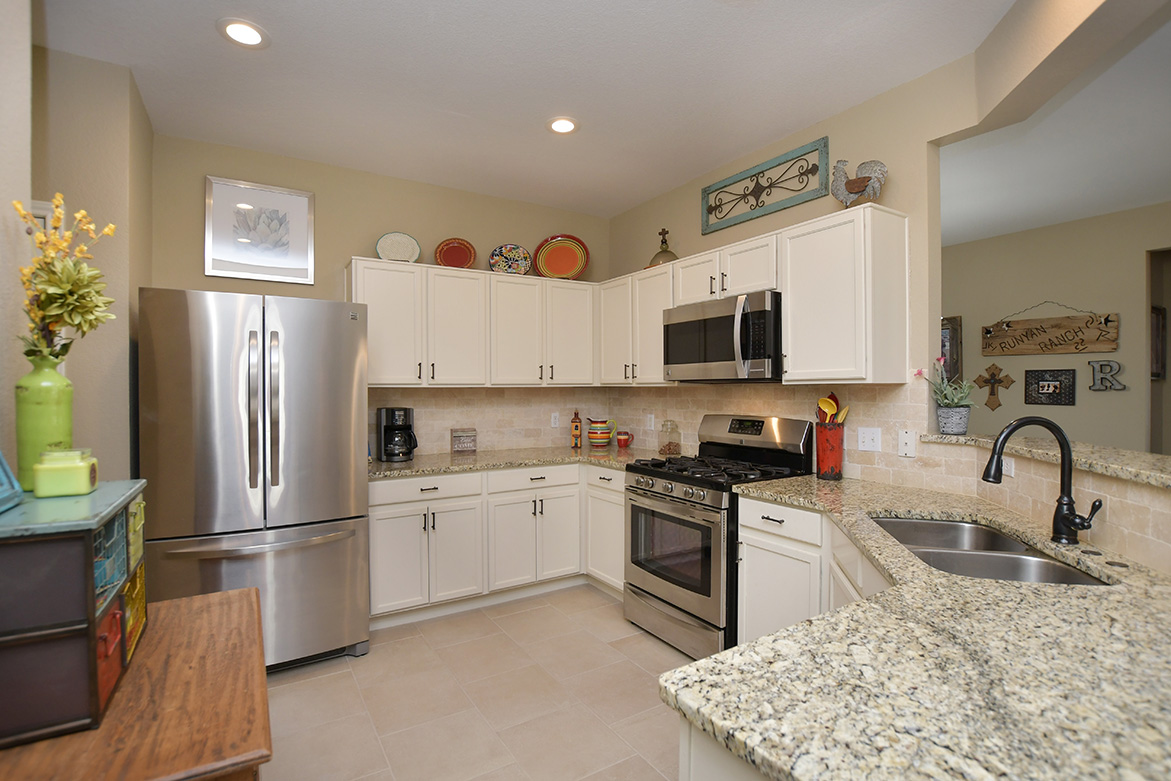 212 Bonham Loop Georgetown, TX 78633 - Photo 10 of 21 White cabinetry, along with stainless appliances and granite counter tops make this kitchen an enjoyable place for whomever is cooking.