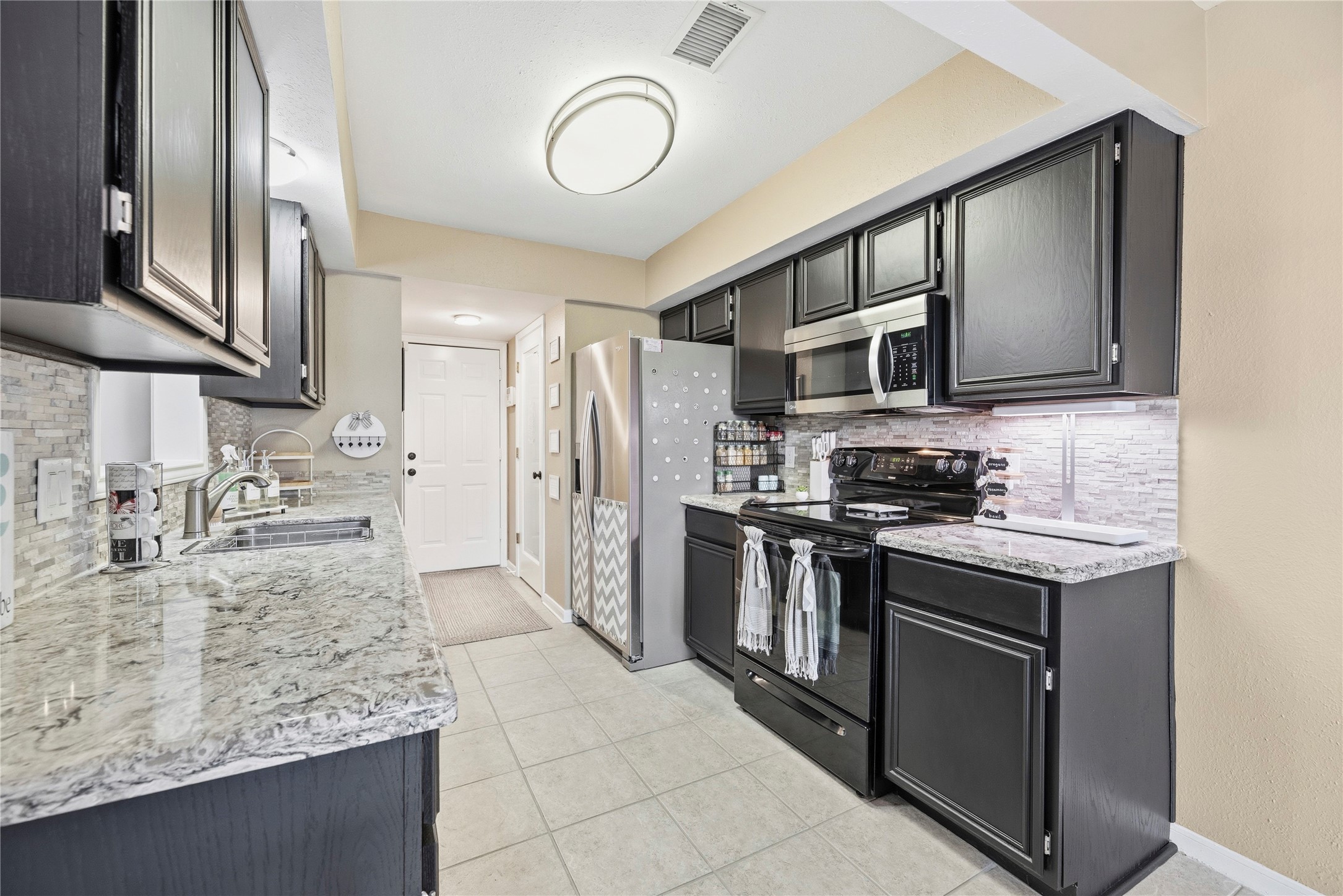 16913 Chapel Pines Drive, Unit 126 Spring, TX 77379 - Photo 10 of 27 This gorgeous, updated kitchen with sleek cabinets, stainless steel appliances, and stunning quartz countertops.